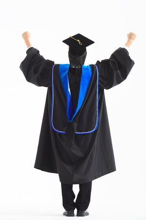 An Asian man with a graduation hat and clothes in the studio, isolated on whiteの写真素材