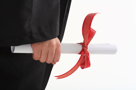 A hand grabbing a letter with red ribbon in the studio, isolated on white.の写真素材