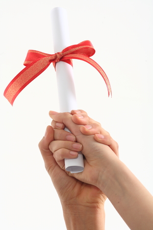 Two hands grabbing a letter with red ribbon in the studio, isolated on white.の写真素材