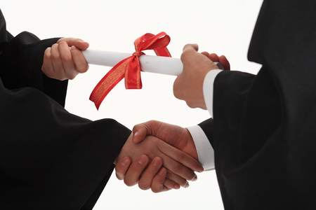 Two hands grabbing a letter with red ribbon in the studio, isolated on white.の写真素材