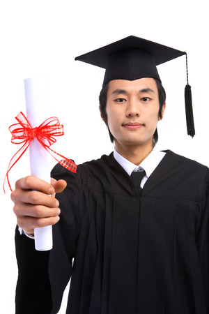 An Asian man with a graduation hat and clothes in the studio, isolated on whiteの写真素材