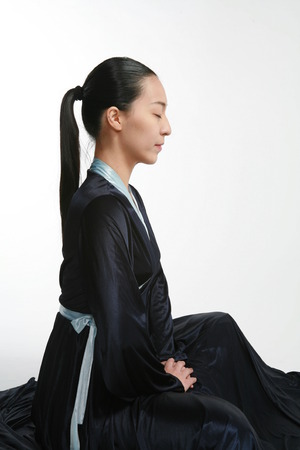 Beautiful Korean female dancer in black Korean traditional dress, Hanbok - isolated on whiteの写真素材
