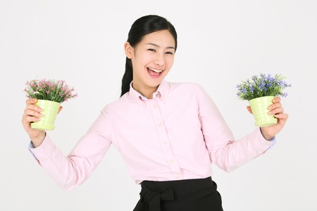 Beautiful young Asian waitress in a studio - isolated on whiteの写真素材