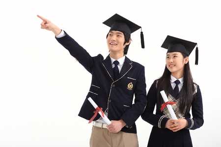 Asian male and female student holding their graduation certificate - isolated on whiteのeditorial素材