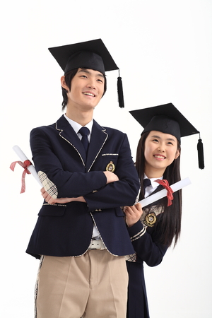 Asian male and female student holding their graduation certificate - isolated on whiteのeditorial素材