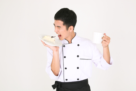 Young Asian male chef in a studio - isolated on whiteの写真素材