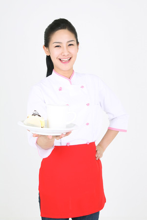 Young Asian female chef in a studio - isolated on whiteの写真素材
