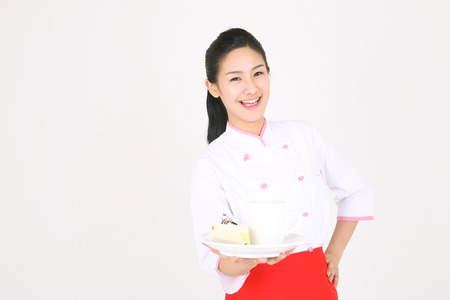 Young Asian female chef in a studio - isolated on whiteの写真素材
