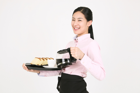 Beautiful young Asian waitress in a studio - isolated on whiteの写真素材