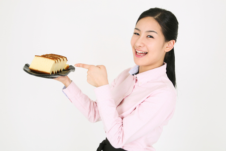 Beautiful young Asian waitress in a studio - isolated on whiteの写真素材