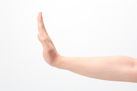 Hand showing stop sign - isolated on whiteの写真素材