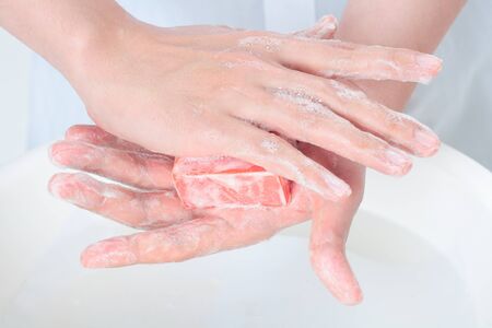 Hands rubbing on the soap - isolated on white