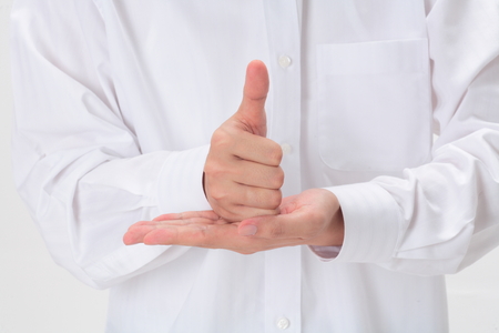 One hand thumb up under one hand support - isolated on whiteの写真素材