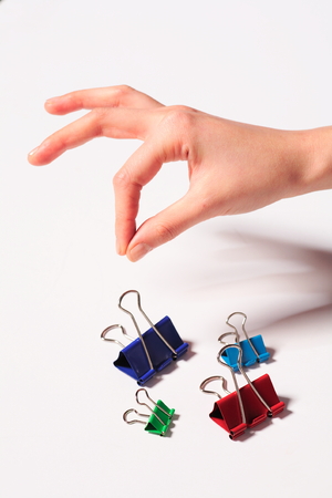 Hand with clips- isolated on whiteの写真素材