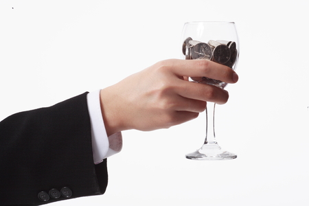 Man holding a glass of moneyの写真素材