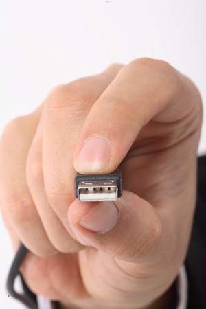 Close-up shot of a hand holding a USB