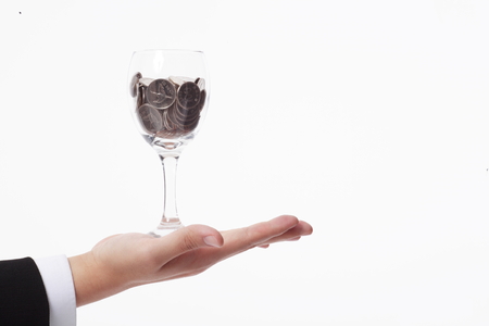 Man holding a glass of moneyの写真素材