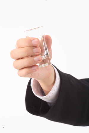 Close-up shot of a hand holding a shot cupの写真素材