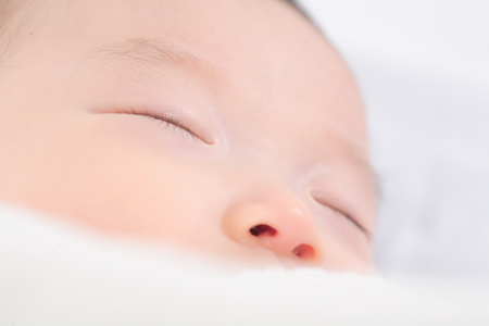 Close-up shot of an Asian baby's faceの写真素材