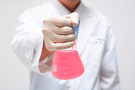 Close-up shot of hands holding flasksの写真素材