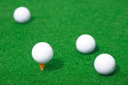 Close-up shot of golf balls lying on the fieldのeditorial素材