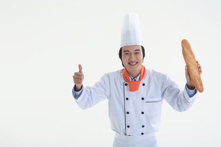 A man holding a loaf of baguette breadの写真素材