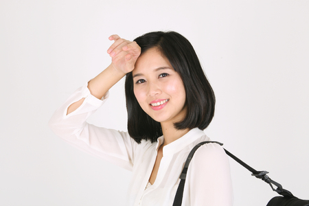 A female violinist carrying a violin case wiping sweatの写真素材
