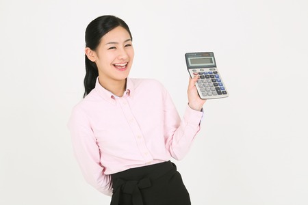 A young waitress holding a calculatorのeditorial素材