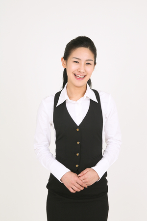A female waitress bowing with smileの写真素材