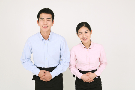 A waiter and a waitress welcomingの写真素材