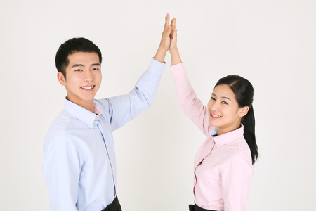 A waiter and a waitress highfiving each otherの写真素材