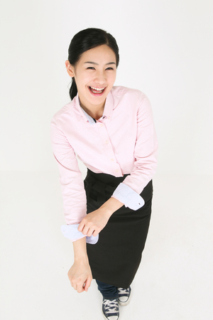 A young waitress folding up sleevesの写真素材