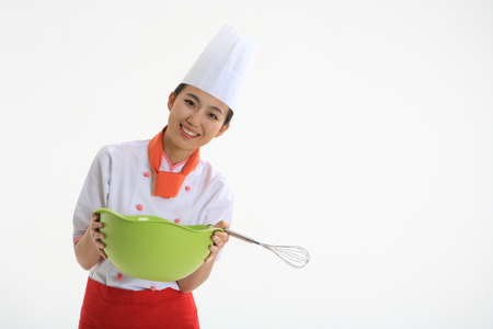 A female cook holding cooker cooking toolの写真素材