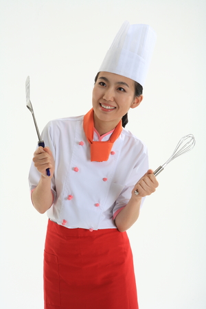A female cook holding cooker cooking toolの写真素材