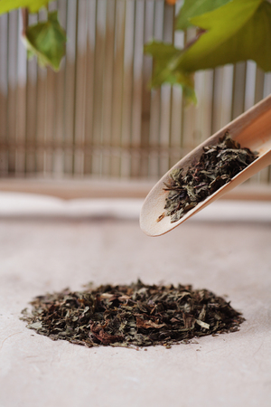 Close up shot of tea leaves in a bamboo scoopの写真素材
