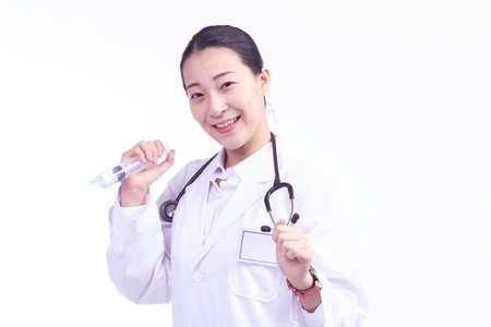 Close up shot of a female doctor holding a tethoscope and holding injection to the sidewayの写真素材
