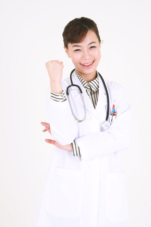 A female doctor with cheering motion with a fist in the airの写真素材
