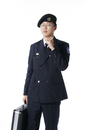 A male soldier wearing glasses showing a fist up as holding a briefcaseのeditorial素材