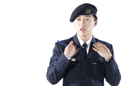 A male soldier explaining as holding a pen in hand at the strategy meetingの写真素材