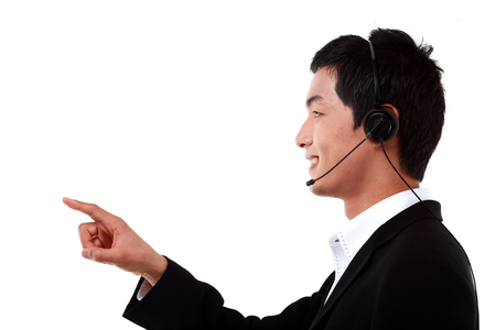 Close up side shot of a male telemarketer pointing with index fingerの写真素材