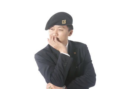 A male soldier wearing glasses resting chin on the handの写真素材