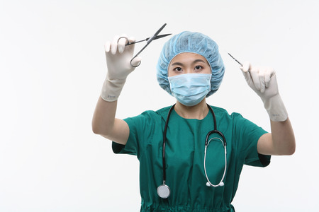 Close up shot of A female surgeon holding surgical equipments in handsの写真素材