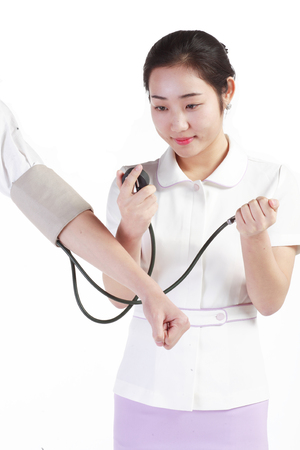 Close up shot of Isolated shot of a female nurse using a sphygmomanometerの写真素材