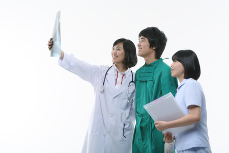 A group of medical staff looking at an x-ray photographsの写真素材