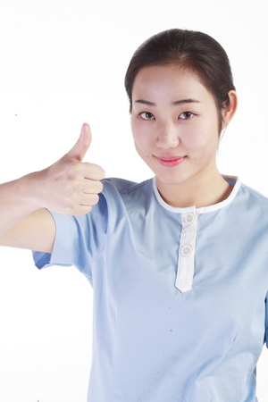 Close up shot of A female physiotherapist showing a thumb up to the frontの写真素材