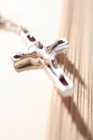 Isolated shot of the rosary laid on the bibleの写真素材
