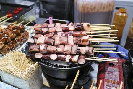 Street food - Skewered octopus/squid/seafoodの写真素材