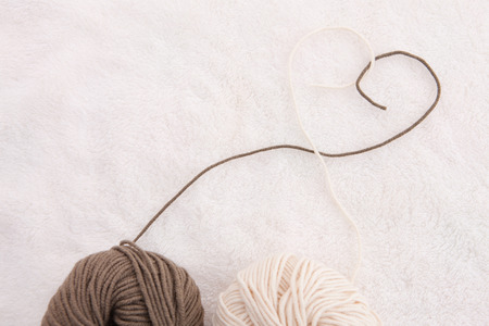 Knitting wool balls and thread heartの写真素材