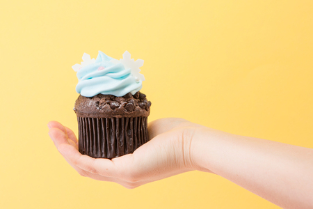 Sweet desserts - Isolated shot of a hand holding a piece of cupcake/muffinの写真素材
