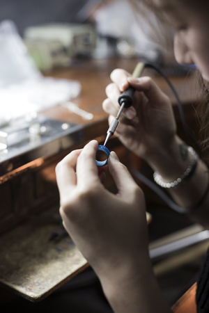 Isolated shot of hands of handmade craft jewerly experts making a piece with/using tools/machinesの写真素材